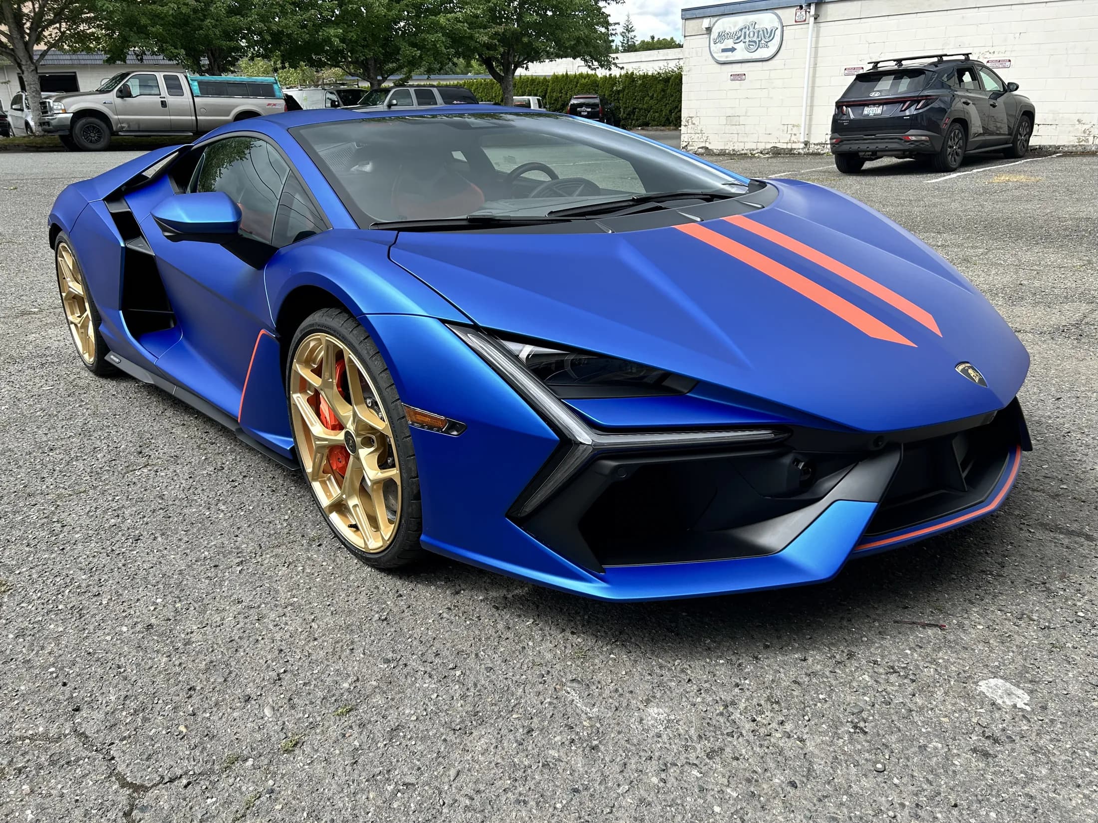 Satin-blue Lamborghini Revuelto with bronze wheels.