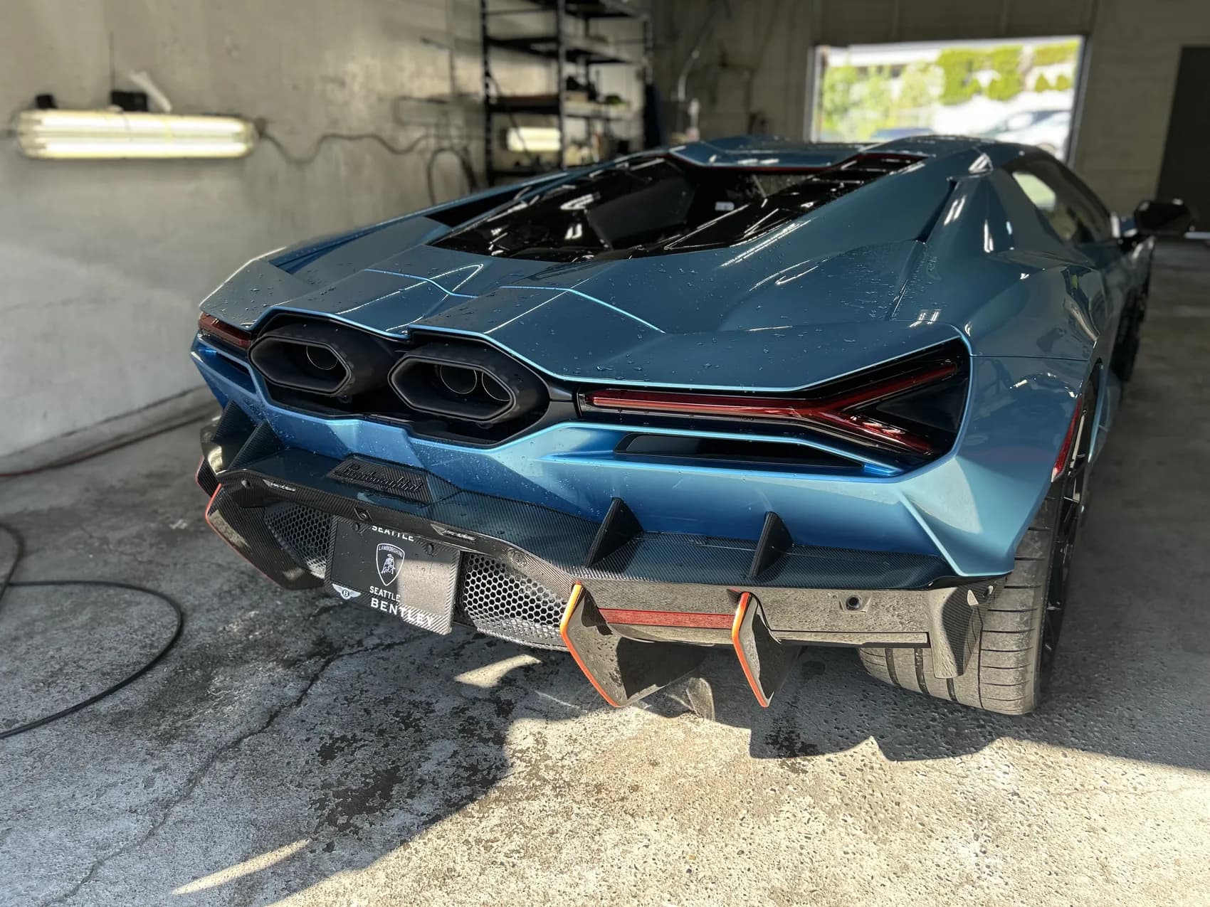 Teal Lamborghini rear in the shop.