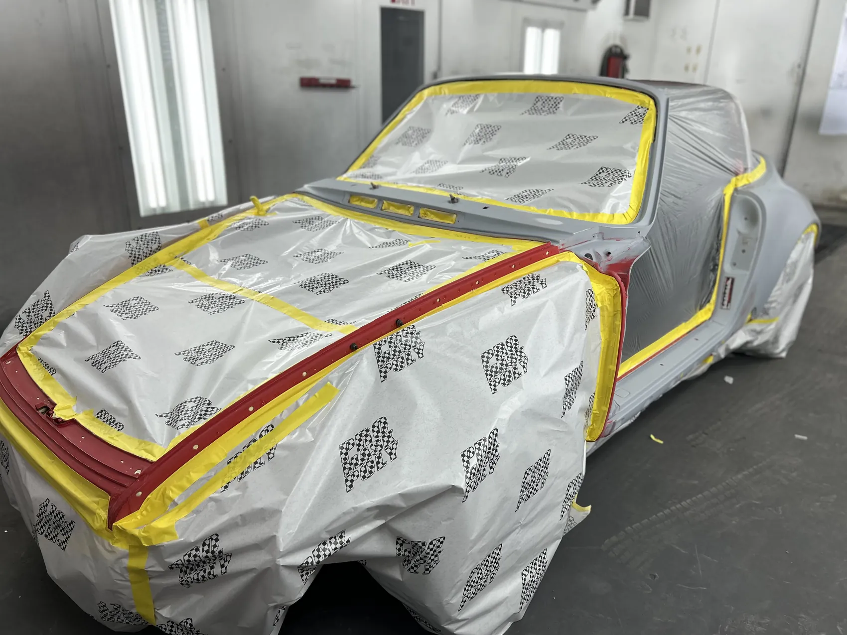 Classic Porsche 911 masked for refinishing.