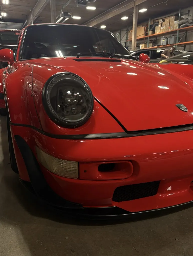 Classic red Porsche 911 front in the shop.